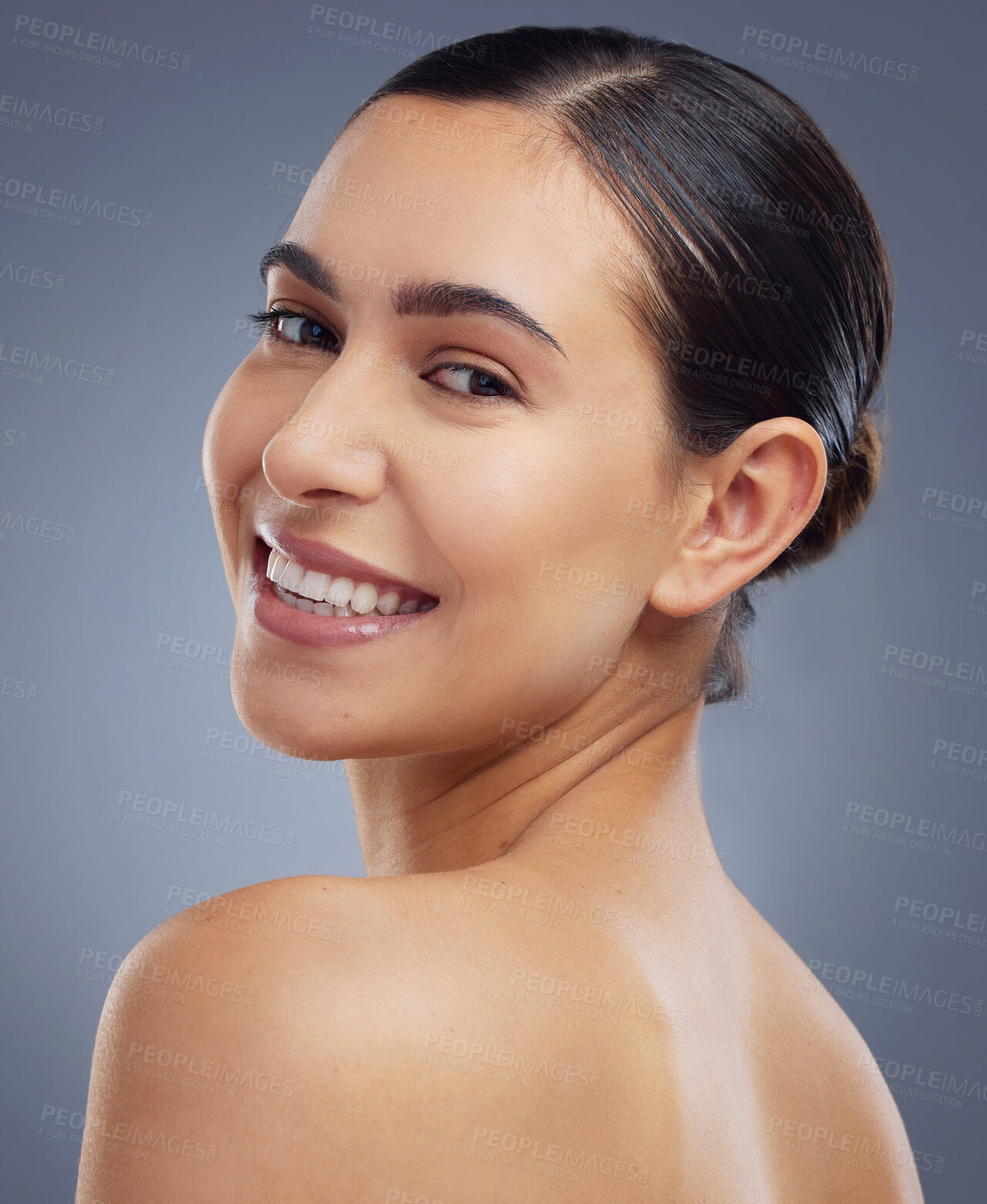 Buy stock photo Studio shot of a beautiful young woman posing against a grey background