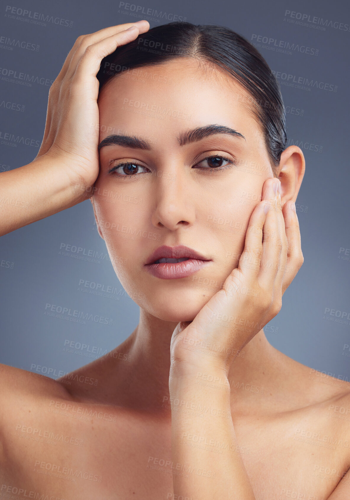 Buy stock photo Studio shot of a beautiful young woman posing against a grey background