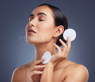 Buy stock photo Studio shot of a beautiful woman holding up cotton pads