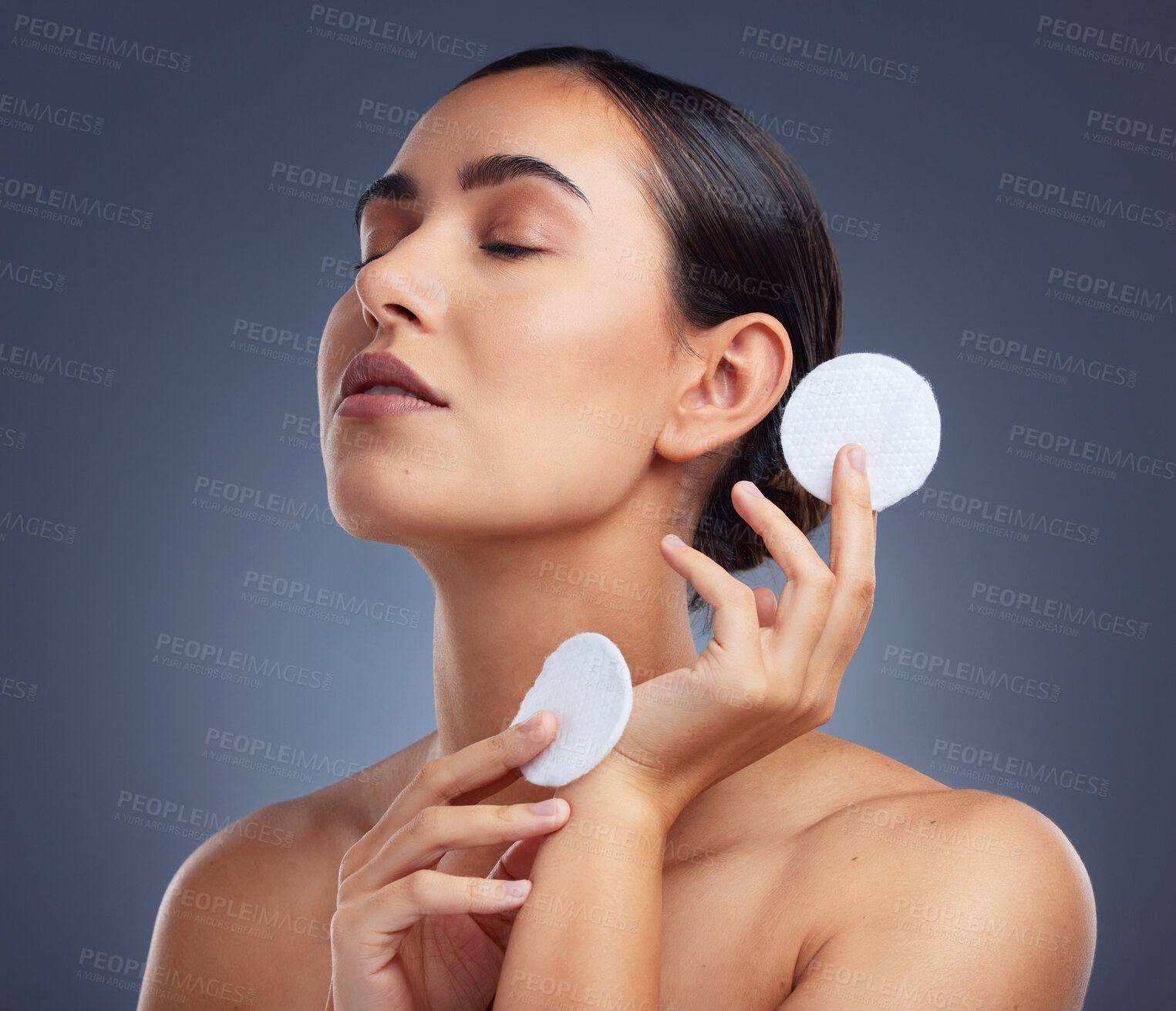 Buy stock photo Studio shot of a beautiful woman holding up cotton pads