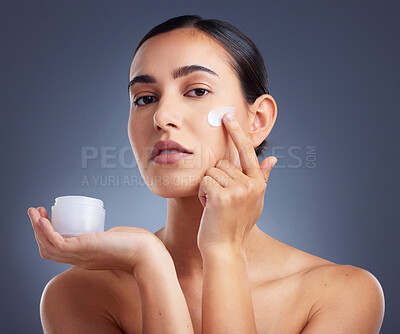 Buy stock photo Studio shot of a beautiful woman using a skincare product
