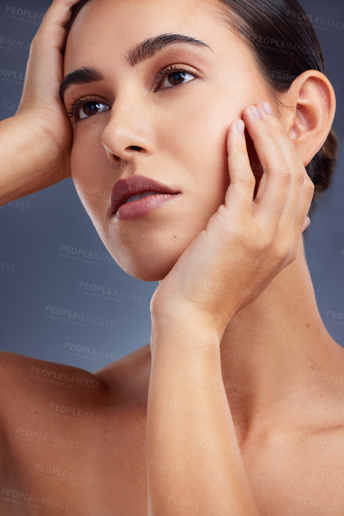 Buy stock photo Studio shot of a beautiful young woman posing against a grey background