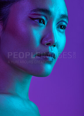 Buy stock photo Cropped shot of an attractive young woman posing in studio against a purple background