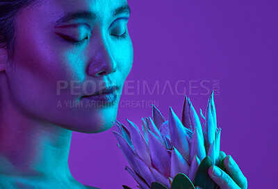 Buy stock photo Cropped shot of an attractive young woman posing in studio against a purple background