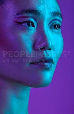 Buy stock photo Cropped shot of an attractive young woman posing in studio against a purple background