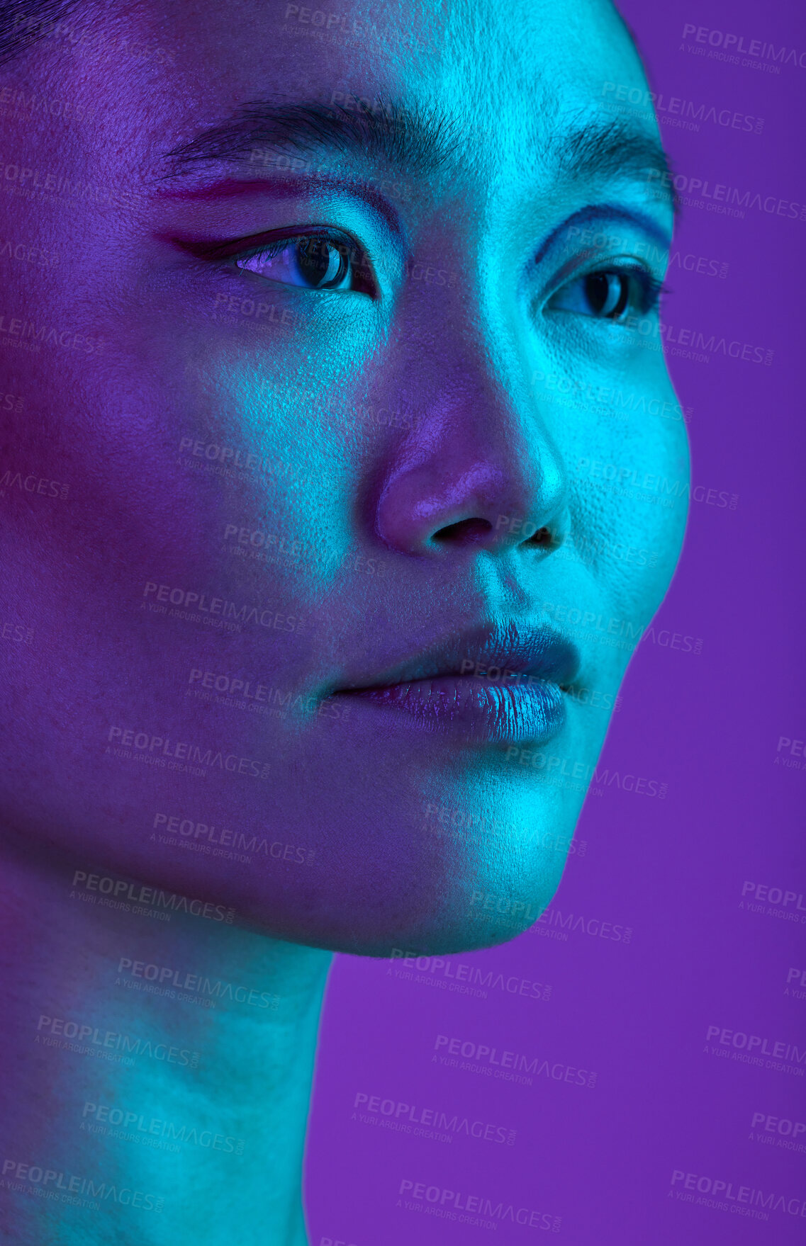 Buy stock photo Cropped shot of an attractive young woman posing in studio against a purple background