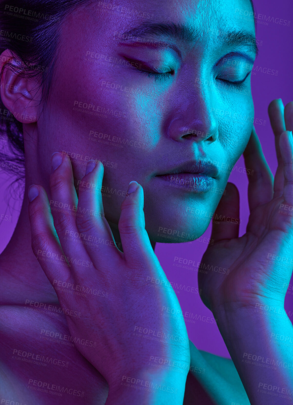 Buy stock photo Cropped shot of an attractive young woman posing in studio against a purple background