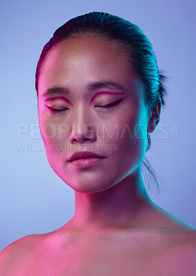 Buy stock photo Cropped shot of an attractive young woman posing in studio against a purple background