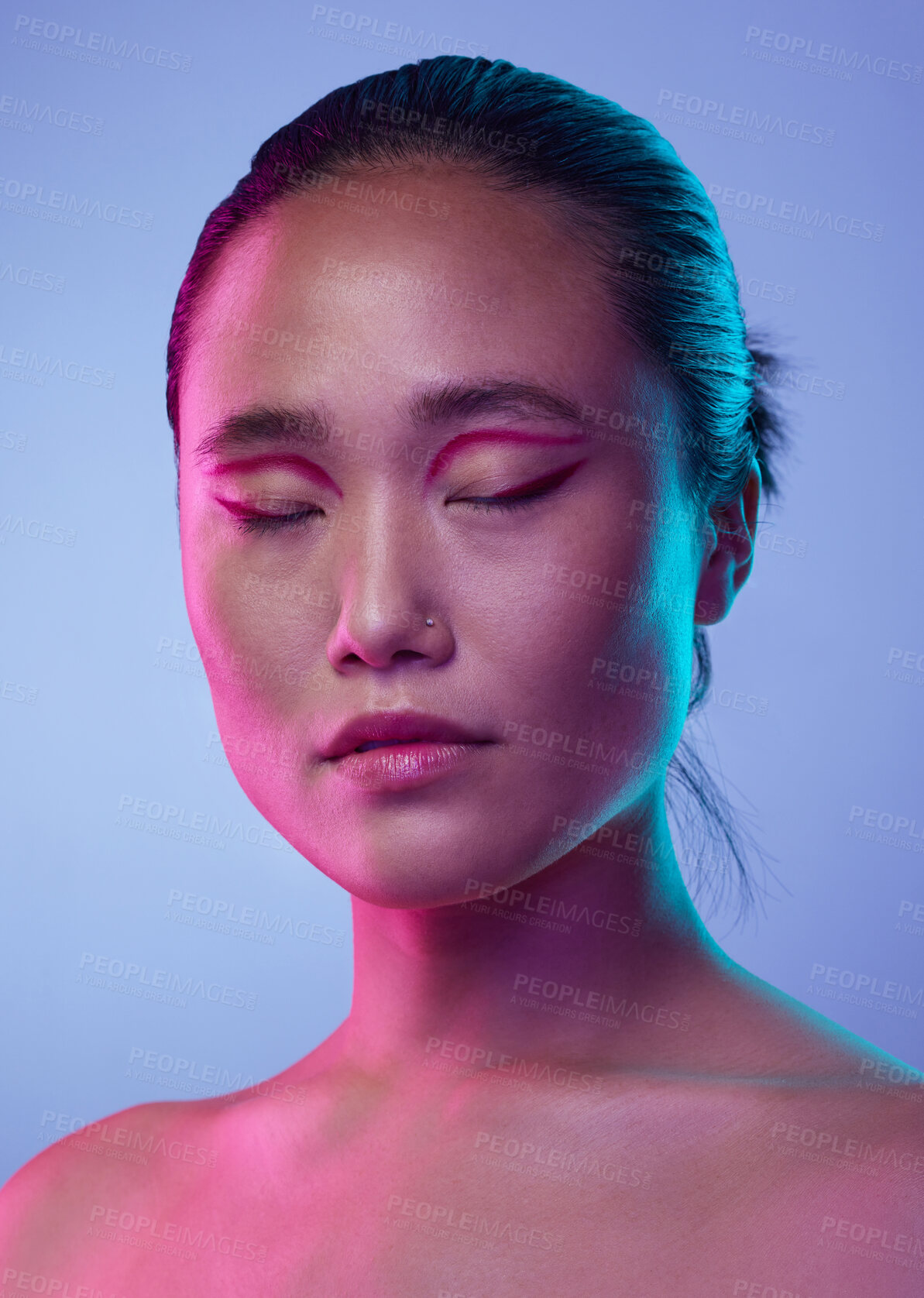 Buy stock photo Cropped shot of an attractive young woman posing in studio against a purple background