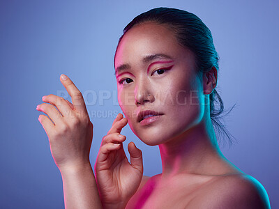 Buy stock photo Cropped shot of an attractive young woman posing in studio against a purple background