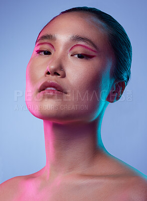 Buy stock photo Cropped shot of an attractive young woman posing in studio against a purple background