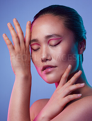 Buy stock photo Cropped shot of an attractive young woman posing in studio against a purple background