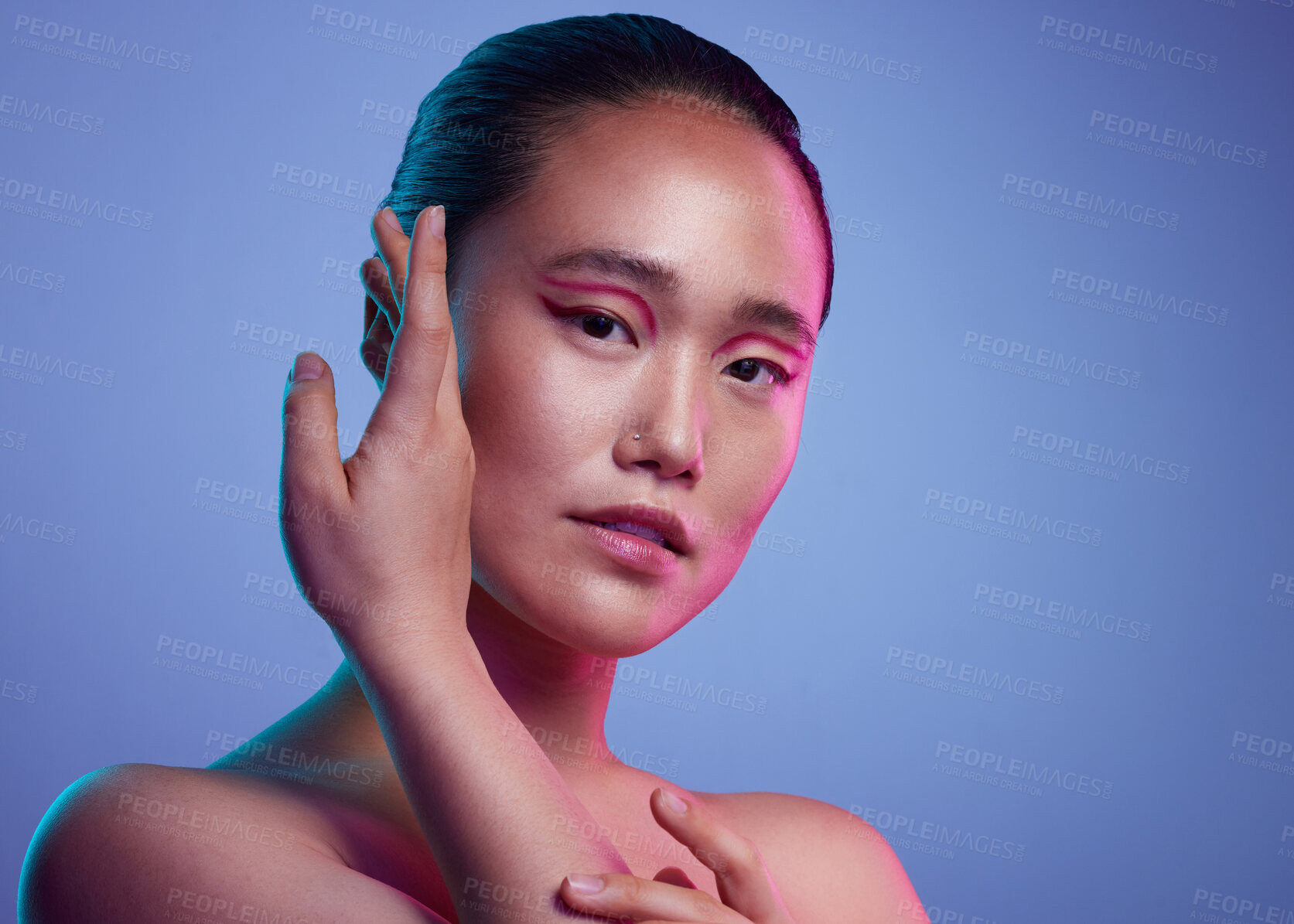 Buy stock photo Cropped shot of an attractive young woman posing in studio against a purple background