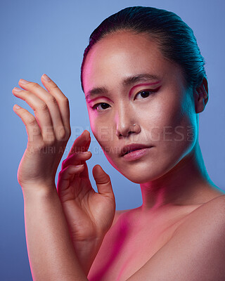 Buy stock photo Cropped shot of an attractive young woman posing in studio against a purple background