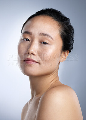 Buy stock photo Shot of a young woman standing against a grey background