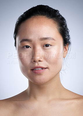 Buy stock photo Shot of a young woman standing against a grey background