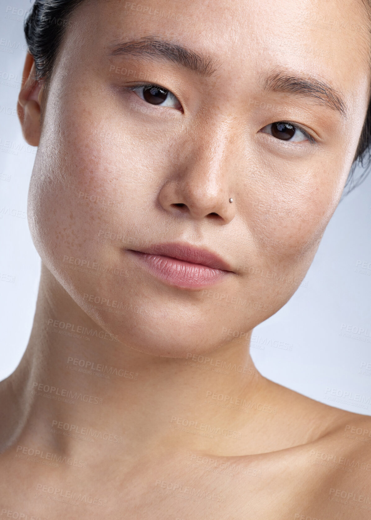 Buy stock photo Shot of a young woman standing against a grey background