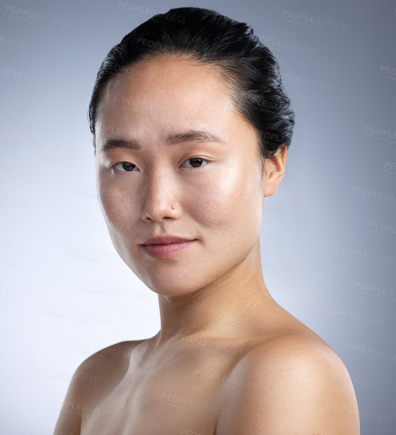 Buy stock photo Shot of a young woman standing against a grey background