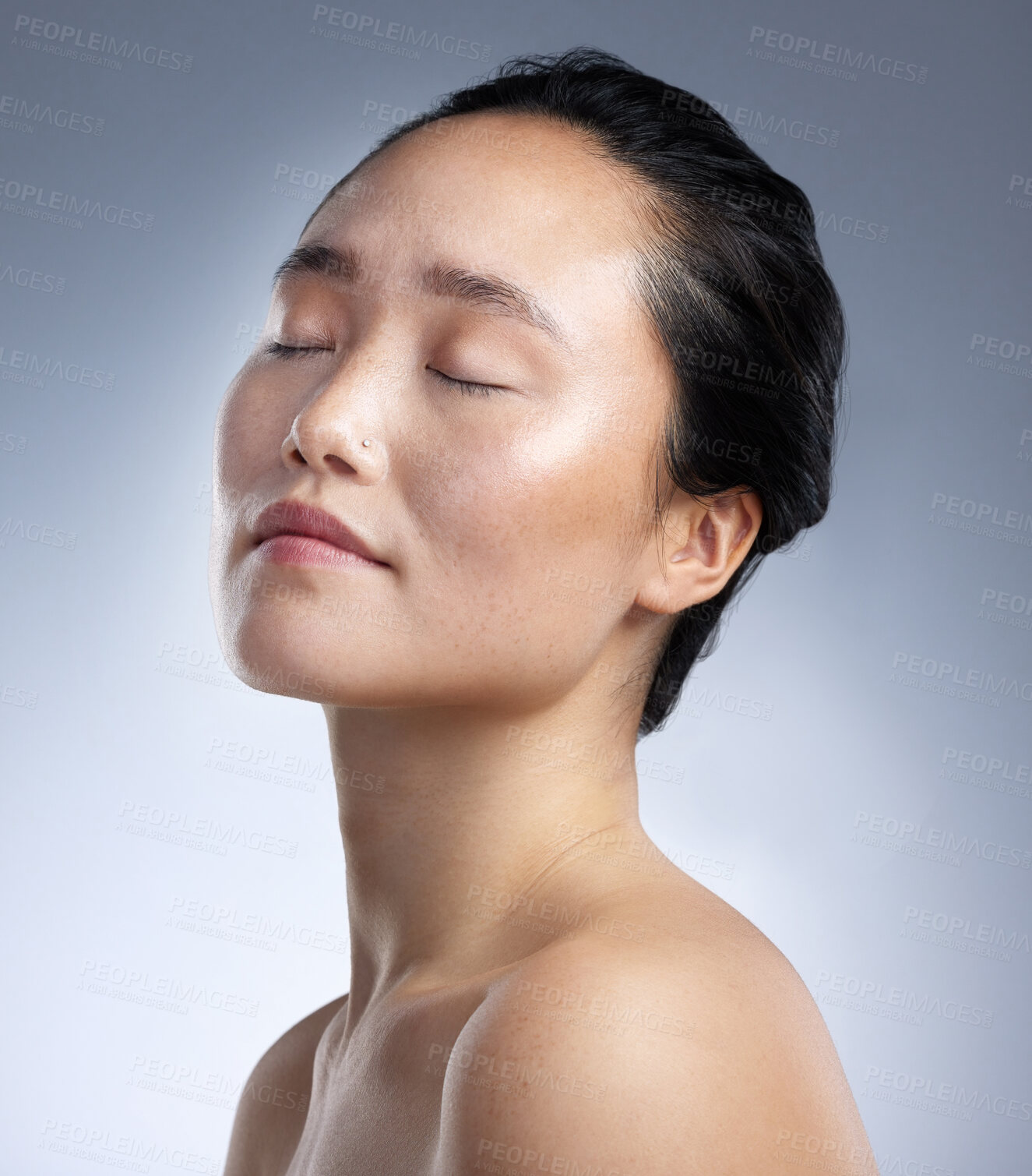 Buy stock photo Shot of a young woman standing against a grey background