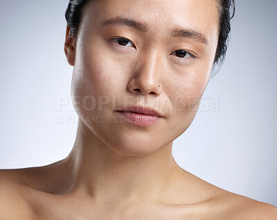 Buy stock photo Shot of a young woman standing against a grey background