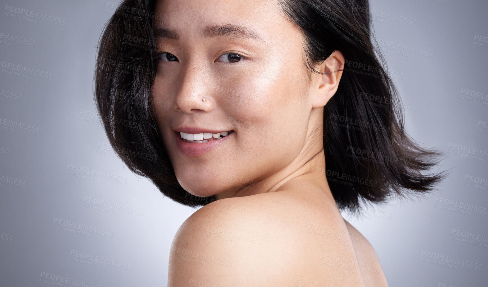 Buy stock photo Shot of a young woman standing against a grey background