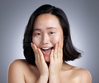 Buy stock photo Shot of a young woman standing against a grey background