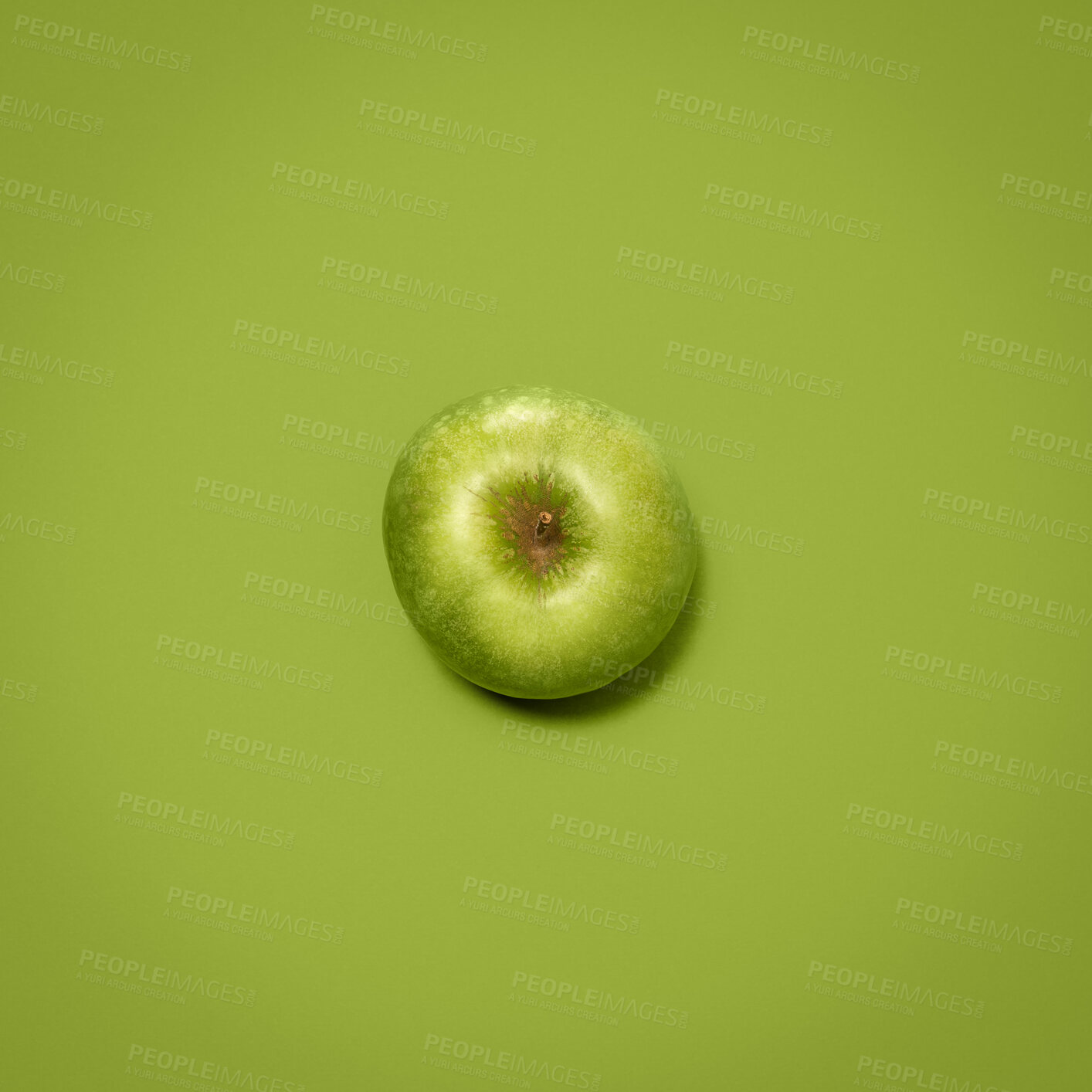 Buy stock photo Shot of a green apple against an empty studio background
