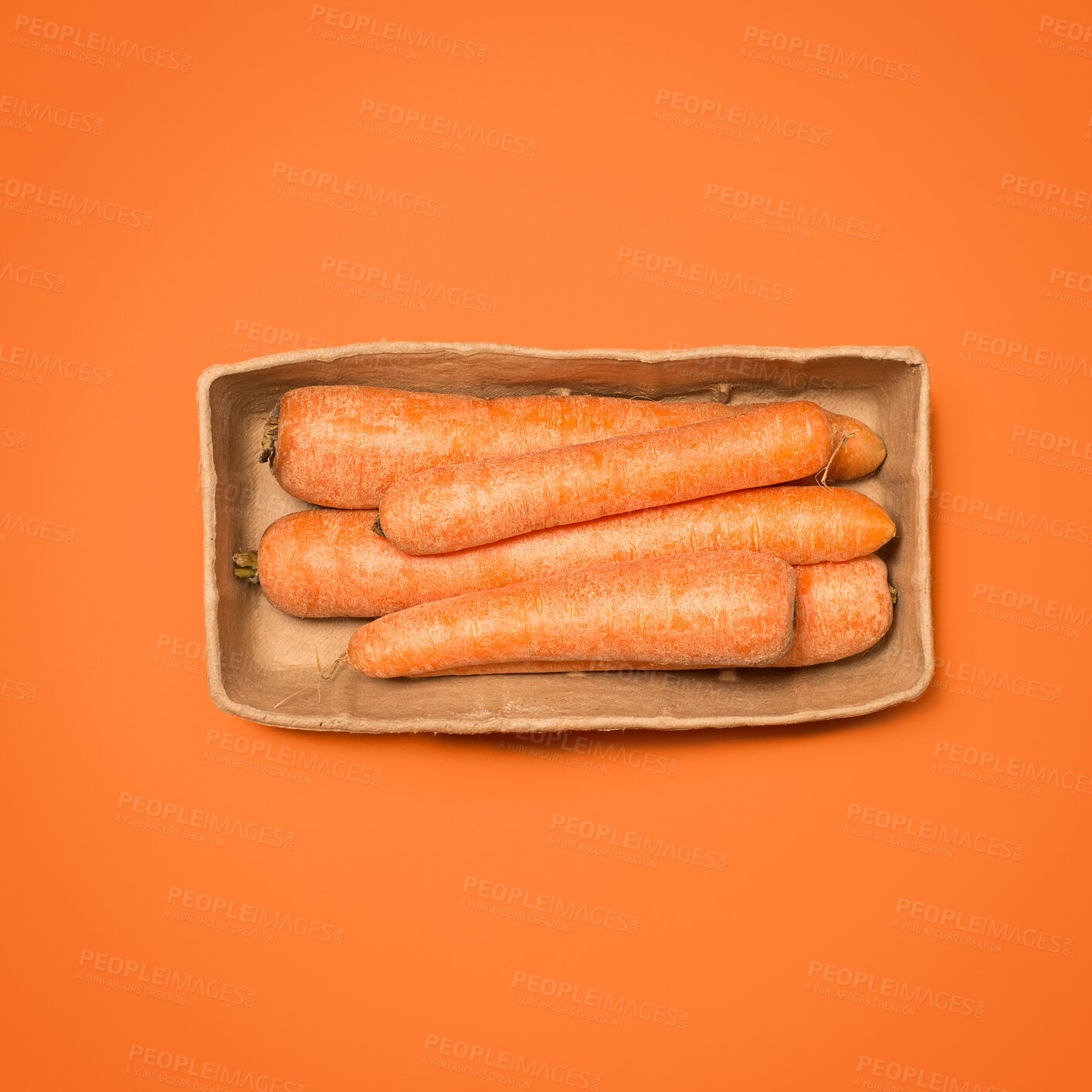Buy stock photo Carrots, vegetable and studio on orange background as ingredient for cooking, nutrition and diet. Food, organic and vegetarian with healthy meal for wellness, health and self care with vitamins