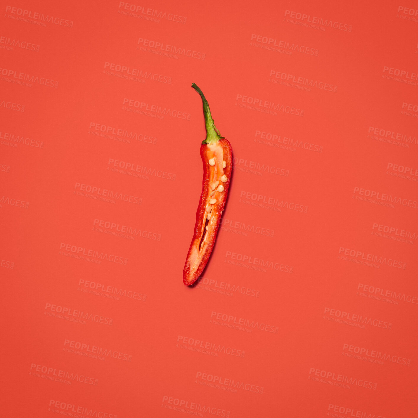 Buy stock photo Red chili, organic and fresh produce in studio for nutrition, digestive health and vitamin c for wellness. Vegetable, culinary and ingredient in red background for cooking, spicy and mockup space