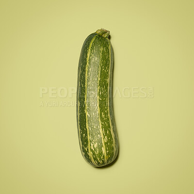 Buy stock photo Crop, green marrow and healthy in studio, vegetable and space for food, nutrition and diet with vitamin. Organic, raw and ingredients for dinner of salad, meal or wellness for menu of vegan in mockup