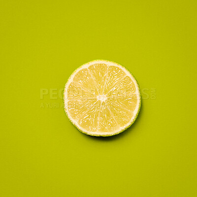 Buy stock photo Slice, lime and nutrition by studio background for wellness, vitamin c and minerals by mockup space. Organic fruit, vegan snack and citric acid by backdrop for diet, aid digestion or hydration