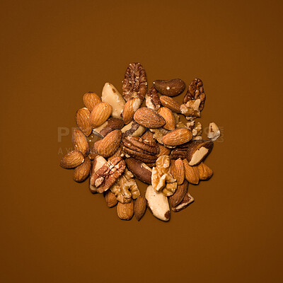 Buy stock photo Food, nuts and nutrition in studio on brown background for snack, lunch and diet for health.  Organic, natural and vegan for healthy cooking for wellness, wellbeing and self care with vitamins