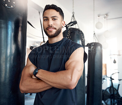 Buy stock photo Portrait of a sporty young woman standing with his arms crossed in a gym