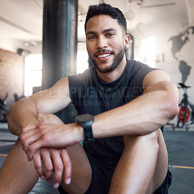 Buy stock photo Portrait of a sporty young man taking a break while exercising in a gym