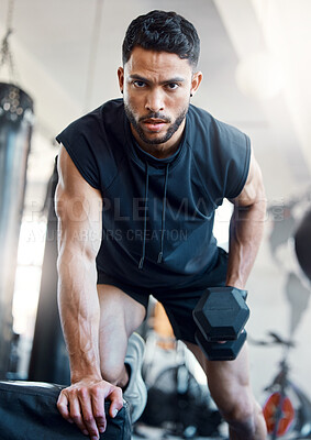 Buy stock photo Portrait of a sporty young man exercising with a dumbbell in a gym