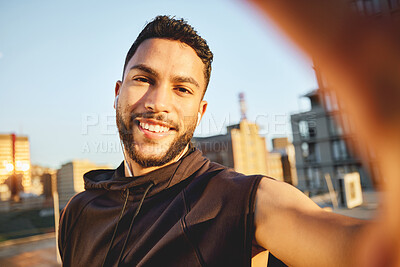 Buy stock photo Shot of a young man taking a selfie while out for a workout