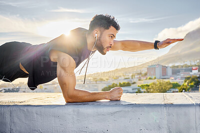 Buy stock photo Shot of a man doing a single-arm plank while on a rooftop