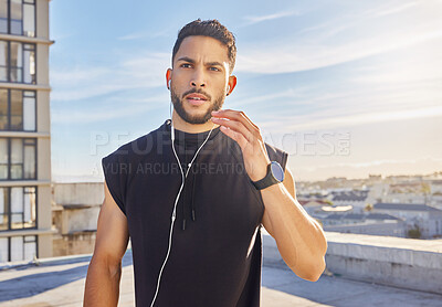 Buy stock photo Shot of a man wearing earphones while standing outside in exercise clothes