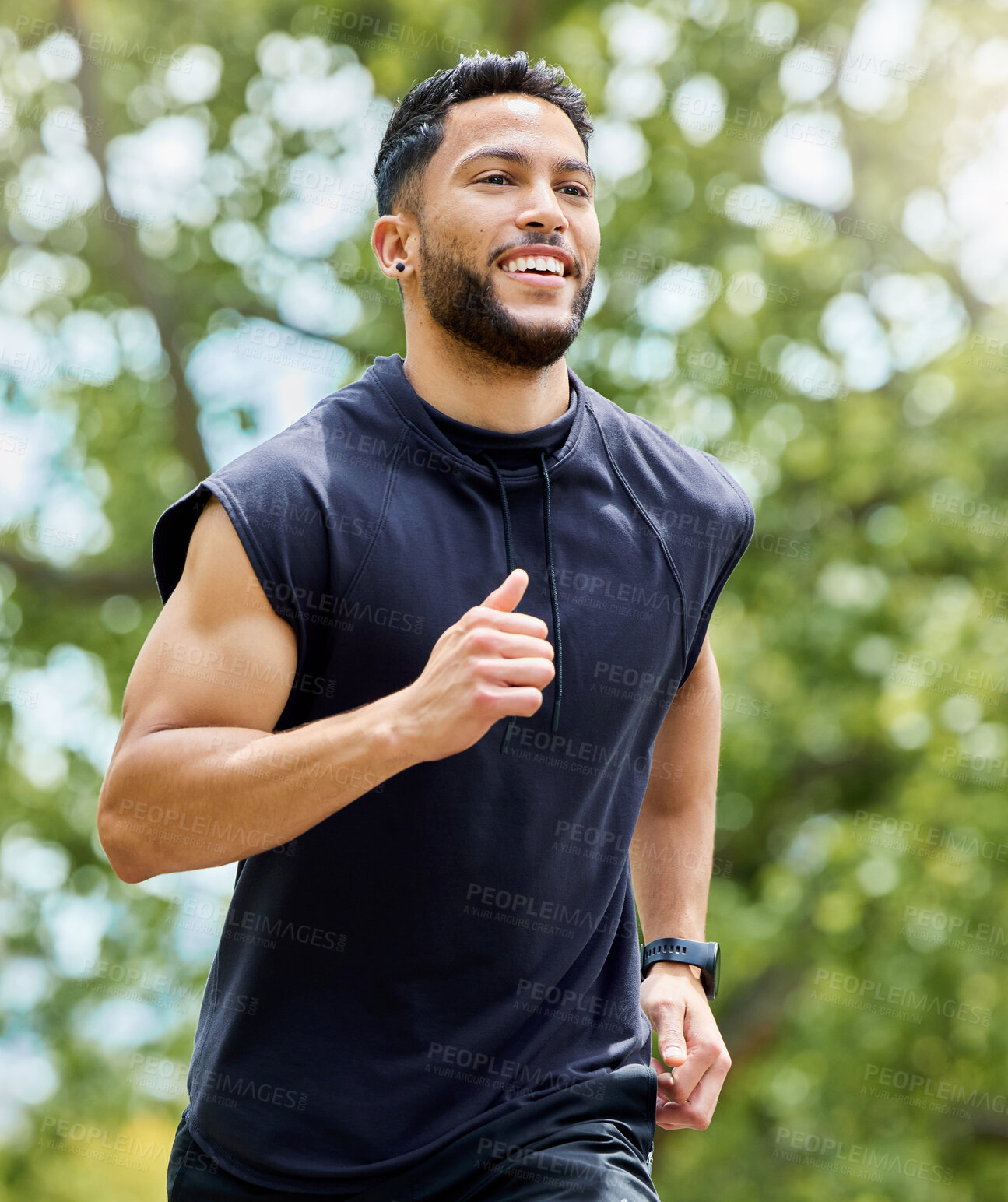 Buy stock photo Shot of a sporty young man running outdoors