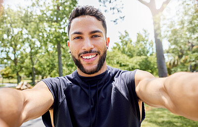 Buy stock photo Portrait of a sporty young man taking selfies while exercising outdoors