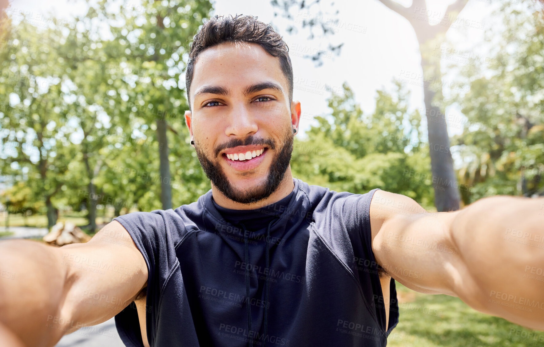 Buy stock photo Portrait of a sporty young man taking selfies while exercising outdoors