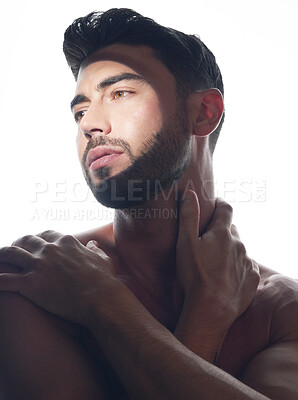 Buy stock photo Studio shot of a handsome young man posing against a white studio background