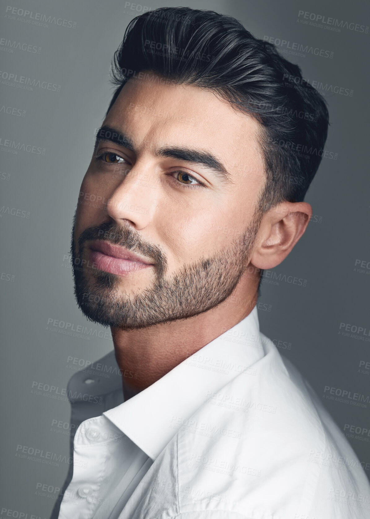 Buy stock photo Studio shot of a handsome young man posing against a grey studio background