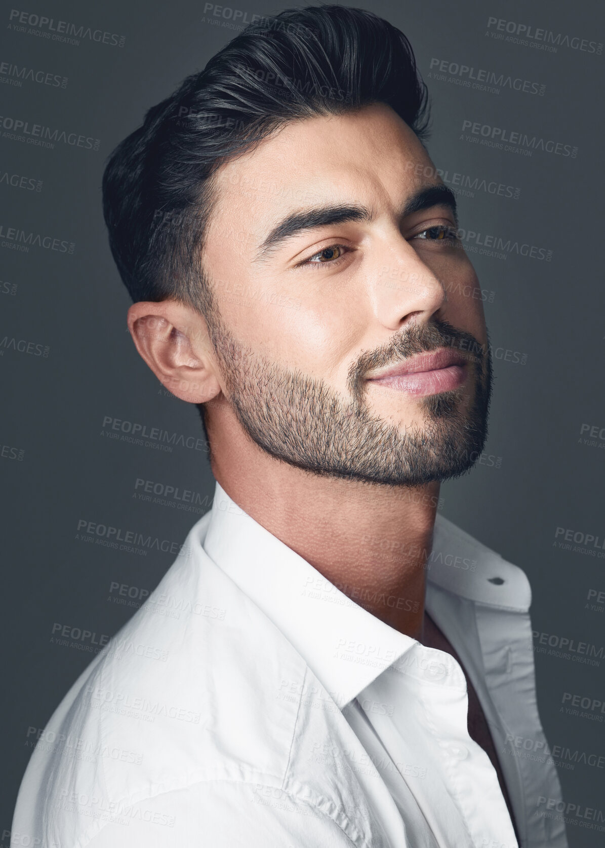 Buy stock photo Studio shot of a handsome young man posing against a grey studio background