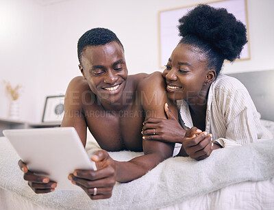 Buy stock photo Shot of a young couple using a digital tablet together at home