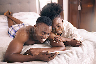 Buy stock photo Shot of a young couple using a digital tablet together at home