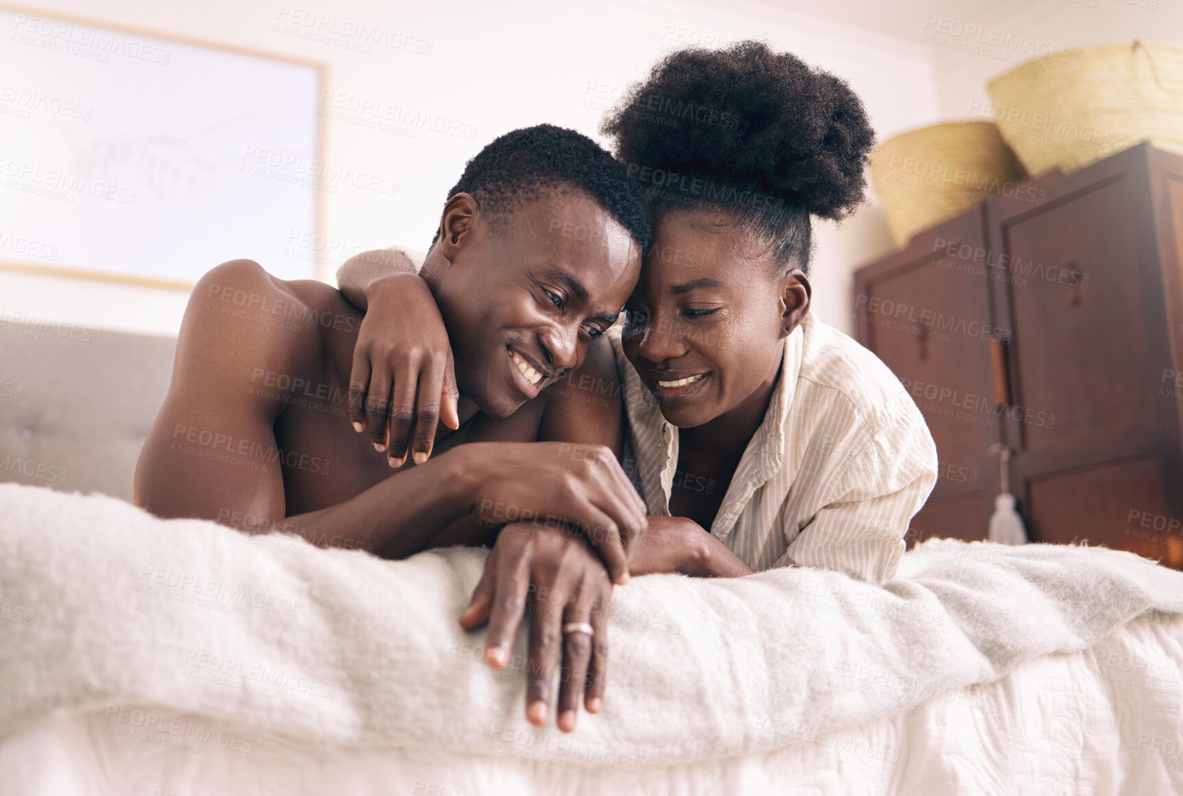 Buy stock photo Shot of a young couple relaxing together at home