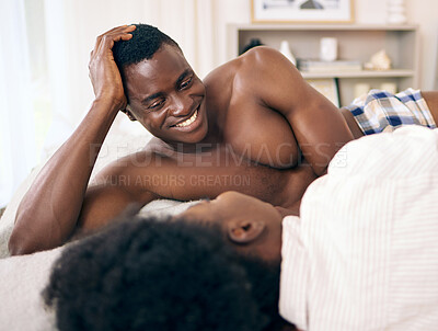 Buy stock photo Shot of a young couple relaxing together at home