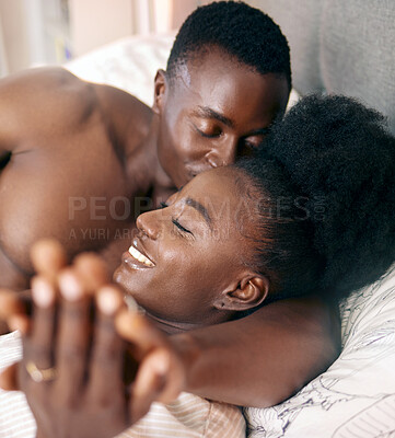 Buy stock photo Shot of a young couple relaxing together at home