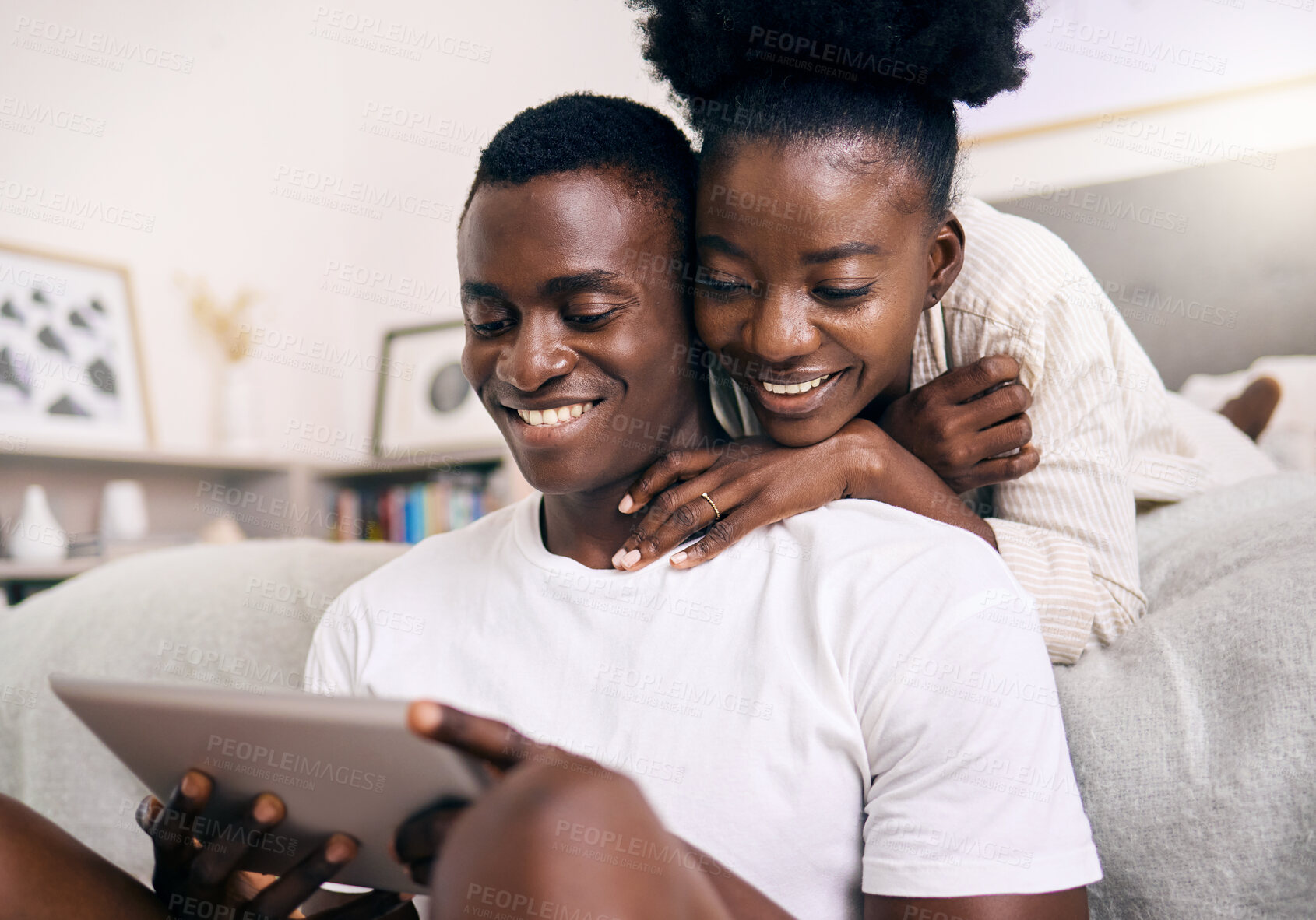 Buy stock photo Shot of a young couple using a digital tablet together at home